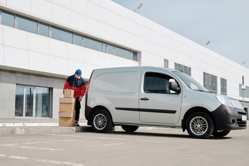 Deliveryman loads pneumatic test fixtures into delivery van.